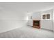 Finished basement with neutral carpet, white walls, fireplace and bright windows at 2777 S Sedalia St, Aurora, CO 80013