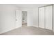 Bright bedroom featuring neutral carpet, white walls, closet and ensuite bathroom at 2777 S Sedalia St, Aurora, CO 80013