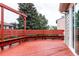 A view of the expansive red deck which has built-in bench seating and lots of room for outdoor entertaining at 2777 S Sedalia St, Aurora, CO 80013