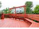 A view of the expansive red deck which has built-in bench seating and lots of room for outdoor entertaining at 2777 S Sedalia St, Aurora, CO 80013