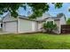 Home featuring a two-car garage, side door, and manicured lawn at 2777 S Sedalia St, Aurora, CO 80013