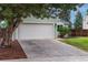 Home featuring a two-car garage, driveway, and well-maintained yard at 2777 S Sedalia St, Aurora, CO 80013