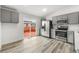 Bright kitchen with gray cabinets, stainless steel appliances, and sliding glass door to the deck at 2777 S Sedalia St, Aurora, CO 80013