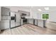 Kitchen with stainless steel appliances and gray cabinetry with abundant natural light at 2777 S Sedalia St, Aurora, CO 80013