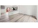 Open-concept living space with hardwood floors and kitchen access at 2777 S Sedalia St, Aurora, CO 80013