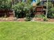 Landscaped backyard featuring a healthy green lawn and wood fencing for enhanced privacy at 4425 E Harvard Ave, Denver, CO 80222