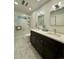 Modern bathroom featuring double sinks, white subway tile in the shower and stylish hexagon tile flooring at 4425 E Harvard Ave, Denver, CO 80222