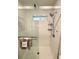 Modern shower featuring white subway tile, glass door, and sleek fixtures at 4425 E Harvard Ave, Denver, CO 80222