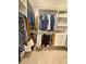 Spacious walk-in closet with custom shelving and hanging rods for organized storage at 4425 E Harvard Ave, Denver, CO 80222