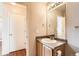 Practical half bathroom featuring a vanity with sink and storage, alongside a convenient doorway at 20229 E Red Fox Ln, Centennial, CO 80015