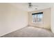 Cozy bedroom featuring neutral walls, plush carpeting, and a large window offering natural light and views at 20229 E Red Fox Ln, Centennial, CO 80015