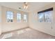 Bright bedroom featuring neutral walls, plush carpeting, and multiple windows providing natural light and outdoor views at 20229 E Red Fox Ln, Centennial, CO 80015