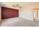 Large bedroom features neutral carpet, updated ceiling fan, and contrasting accent wall at 20229 E Red Fox Ln, Centennial, CO 80015