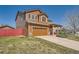 Charming two-story home featuring a well-maintained front yard and a two-car garage at 20229 E Red Fox Ln, Centennial, CO 80015