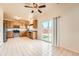 Bright kitchen features wood cabinets, stainless steel appliances, and sliding door to the backyard at 20229 E Red Fox Ln, Centennial, CO 80015