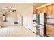 Eat-in kitchen featuring stainless steel appliances and tiled floors at 20229 E Red Fox Ln, Centennial, CO 80015