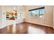 Open-concept living room and kitchen with hardwood floors and large windows, ideal for modern living at 20229 E Red Fox Ln, Centennial, CO 80015