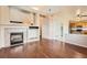 Spacious living room with fireplace, hardwood floors, and ample natural light creates a warm, inviting atmosphere at 20229 E Red Fox Ln, Centennial, CO 80015