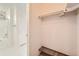 A functional walk-in closet offers great storage with shelves and access to an updated bathroom featuring tiled flooring at 20229 E Red Fox Ln, Centennial, CO 80015