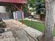 Landscaped backyard featuring a shed, stone patio, and a well-maintained lawn at 14963 E Adriatic Pl, Aurora, CO 80014