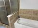 Bathroom with tiled shower with glass door and white bathtub with chrome faucet at 14963 E Adriatic Pl, Aurora, CO 80014