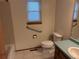 Bathroom with essential features including a toilet, a sink with mirror, and a shower at 14963 E Adriatic Pl, Aurora, CO 80014
