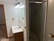 A well-lit bathroom features a shower, vanity with storage, and decorative fixtures alongside a mirrored medicine cabinet at 14963 E Adriatic Pl, Aurora, CO 80014