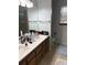 Bathroom with a double sink vanity, large mirror, and neutral finishes at 14963 E Adriatic Pl, Aurora, CO 80014