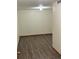 Empty room featuring wood-look floors, fresh white paint, and lots of natural light at 14963 E Adriatic Pl, Aurora, CO 80014