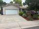 Charming home featuring a two-car garage, well-maintained lawn, and mature landscaping at 14963 E Adriatic Pl, Aurora, CO 80014