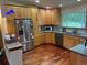 Spacious kitchen featuring oak cabinets, granite countertops, and modern stainless steel appliances at 14963 E Adriatic Pl, Aurora, CO 80014