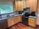 Functional kitchen featuring wooden cabinets, granite countertops, and stainless-steel appliances at 14963 E Adriatic Pl, Aurora, CO 80014
