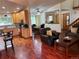 Open-concept living room seamlessly connecting to the kitchen and dining area with hardwood floors at 14963 E Adriatic Pl, Aurora, CO 80014