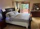 Cozy main bedroom with access to a private balcony and an abundance of natural light at 14963 E Adriatic Pl, Aurora, CO 80014