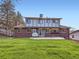 Large backyard with patio, great lawn and two-story home with brick and siding at 6768 Vivian St, Arvada, CO 80004
