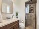 Updated bathroom with modern fixtures, a sleek glass shower, and stylish design elements at 6768 Vivian St, Arvada, CO 80004