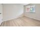 Bright bedroom features neutral walls, updated baseboards and light, wood-look vinyl floors at 6768 Vivian St, Arvada, CO 80004