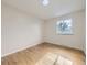 Bright bedroom featuring hardwood floors and a large window offering natural light and views at 6768 Vivian St, Arvada, CO 80004