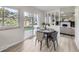 Bright breakfast nook features a table for four, sliding door access to a backyard view, and an open design at 6768 Vivian St, Arvada, CO 80004
