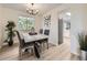 Stylish dining area with modern light fixture and adjacent access to the kitchen at 6768 Vivian St, Arvada, CO 80004