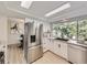 Modern kitchen with stainless steel appliances, white cabinetry, and a large window offering natural light at 6768 Vivian St, Arvada, CO 80004