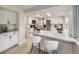 Spacious kitchen with stainless appliances, counter seating, and ample countertop space for meal preparation at 6768 Vivian St, Arvada, CO 80004