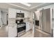 Well-equipped kitchen with stainless steel appliances, modern cabinets, and an efficient layout at 6768 Vivian St, Arvada, CO 80004