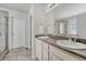 Well-lit bathroom featuring double sinks, a large mirror, and a glass-enclosed shower at 7686 Grady Cir, Castle Rock, CO 80108