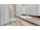 Bright bathroom featuring a shower-tub combination with a white shower curtain and a single sink vanity at 7686 Grady Cir, Castle Rock, CO 80108