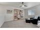 Bedroom with plush carpet, a ceiling fan, and built in bookshelves at 7686 Grady Cir, Castle Rock, CO 80108
