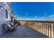 Spacious wooden deck with comfortable seating and a beautiful view of the surrounding neighborhood under a blue sky at 7686 Grady Cir, Castle Rock, CO 80108