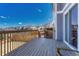 Large wooden deck overlooking a well-maintained backyard with a glimpse of the neighborhood beyond at 7686 Grady Cir, Castle Rock, CO 80108