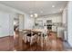 Dining area with hardwood floors, kitchen view, and contemporary lighting fixture at 7686 Grady Cir, Castle Rock, CO 80108