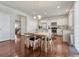 Open dining area showcasing hardwood floors, an adjacent kitchen, and plenty of natural light at 7686 Grady Cir, Castle Rock, CO 80108